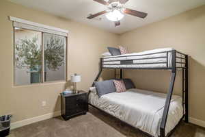 Carpeted bedroom with ceiling fan