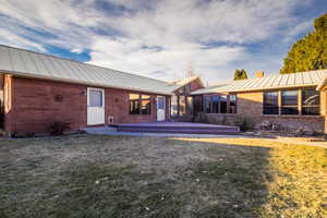 Back of house with a lawn