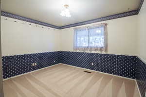 Unfurnished room featuring carpet