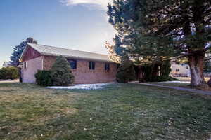 Property exterior at dusk with a yard
