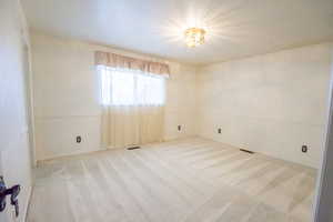 Spare room featuring carpet flooring