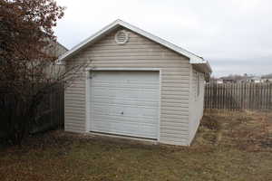 Garage featuring a lawn