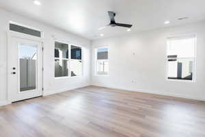 Unfurnished room with ceiling fan and light hardwood / wood-style floors