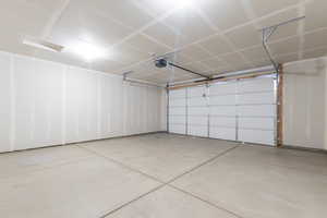 Garage featuring a garage door opener