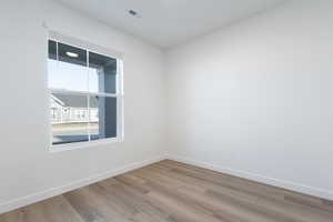 Spare room featuring light wood-type flooring