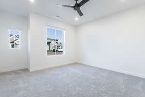 Unfurnished room featuring carpet floors and ceiling fan