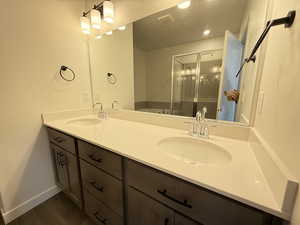 Bathroom with wood-type flooring, vanity, and independent shower and bath