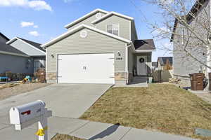 View of front of home featuring a garage and a front lawn