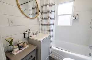 Full bathroom featuring vanity, toilet, and shower / tub combo with curtain