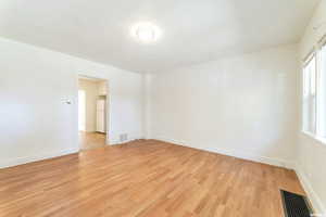 Empty room with light hardwood / wood-style floors