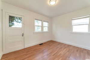 Foyer entrance featuring plenty of natural light and light wood-type flooring