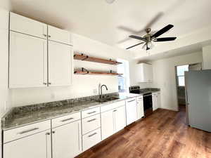 Kitchen with refrigerator, sink, electric range, dishwasher, and white cabinets