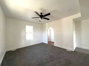 Carpeted empty room with ceiling fan