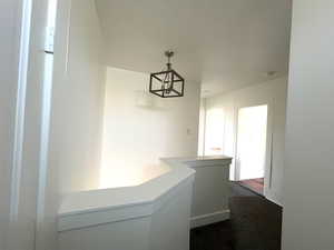 Upstairs hall with an inviting chandelier