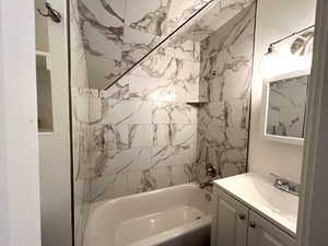 Full Bathroom featuring vanity and tiled shower / bath