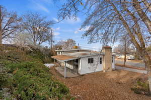 View of side of home with a patio