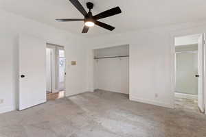 Unfurnished bedroom featuring a closet, light colored carpet, and ceiling fan