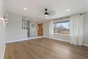 Living room featuring ceiling fan and light hardwood / wood-style floors