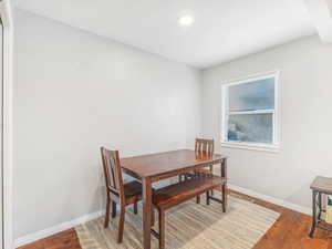 Dining area featuring dark wood-type flooring