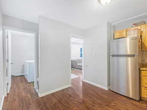 Interior space featuring washing machine and dryer and dark hardwood / wood-style flooring