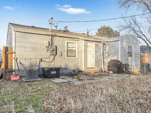 Rear view of house featuring cooling unit