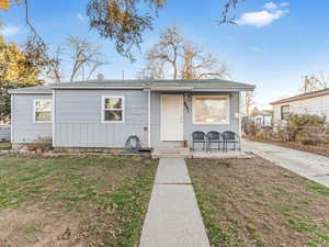 View of front of home featuring a porch and a front lawn