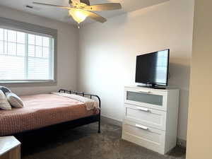 Carpeted bedroom with ceiling fan