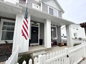 Doorway to property featuring covered porch