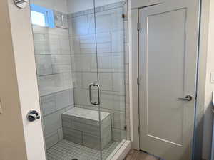 Bathroom featuring vanity and a shower with shower door