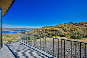 Balcony with a water and mountain view