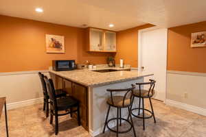 Second Kitchen with granite countertops and kitchen peninsula