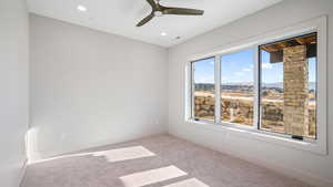 Unfurnished room with light carpet and ceiling fan