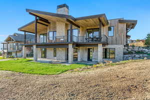 Rear view of house featuring a patio area and a balcony