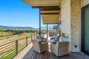 Deck with an outdoor living space with a fireplace and a mountain view