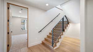 Staircase with hardwood / wood-style floors