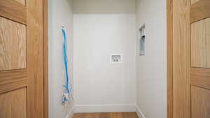 Washroom featuring hookup for a washing machine and hardwood / wood-style floors