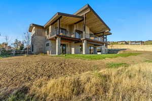 Back of property featuring a balcony