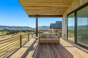 Wooden deck with outdoor lounge area and a mountain view