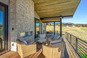 Wooden deck with an outdoor stone fireplace