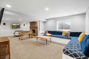 Lower level family room featuring game room area, a fireplace and carpet floors