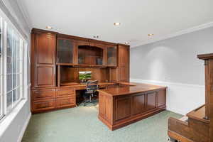 Office area with built in cabinets and crown molding