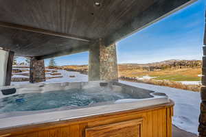 Exterior space with a mountain view and a hot tub