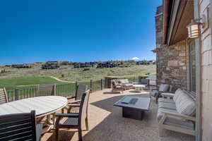 View of patio / terrace featuring a grill and an outdoor living space with a fire pit