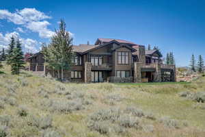 Rear view of house featuring a wooden deck