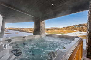 View of pool featuring a hot tub