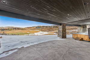 Snow covered patio featuring a mountain view