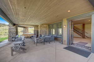 View of patio featuring an outdoor hangout area and a hot tub