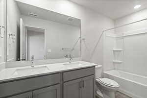 Full bathroom featuring vanity, hardwood / wood-style flooring, toilet, and shower / bath combination