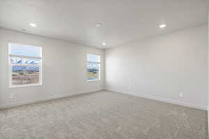 Unfurnished room with a healthy amount of sunlight and carpet floors