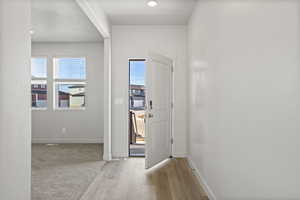 Hallway with light hardwood / wood-style floors